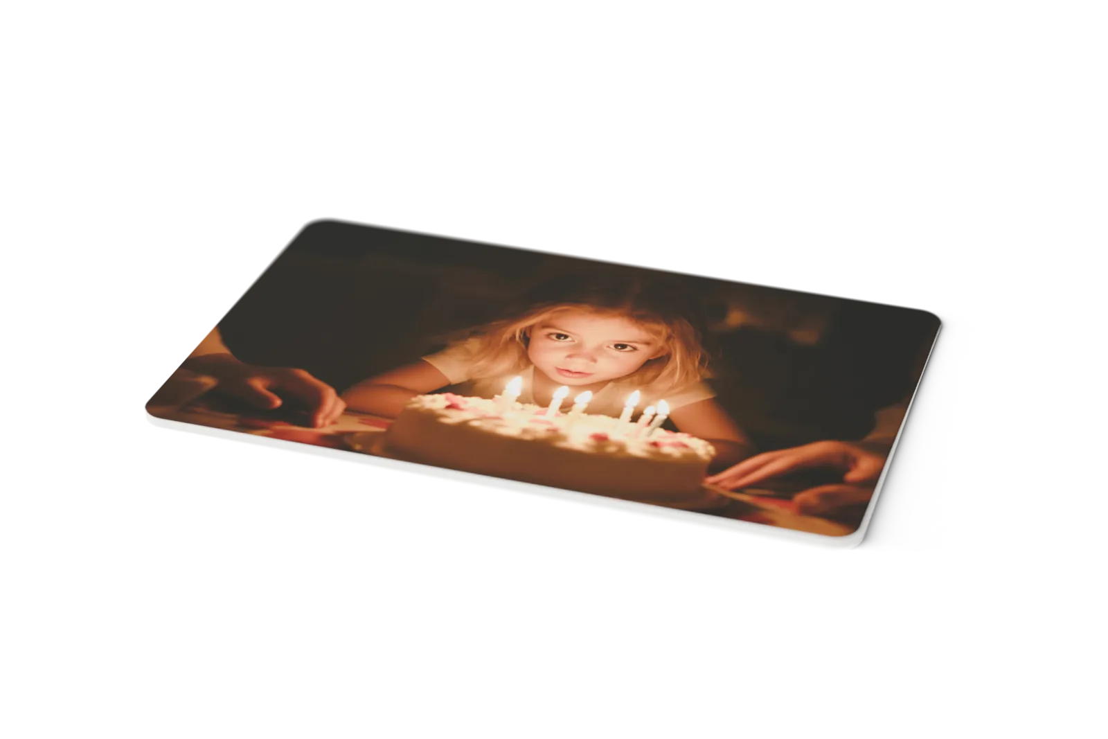 A single Dote card seen close up, showing the printed photograph, the rounded corner and the thickness of the card edge